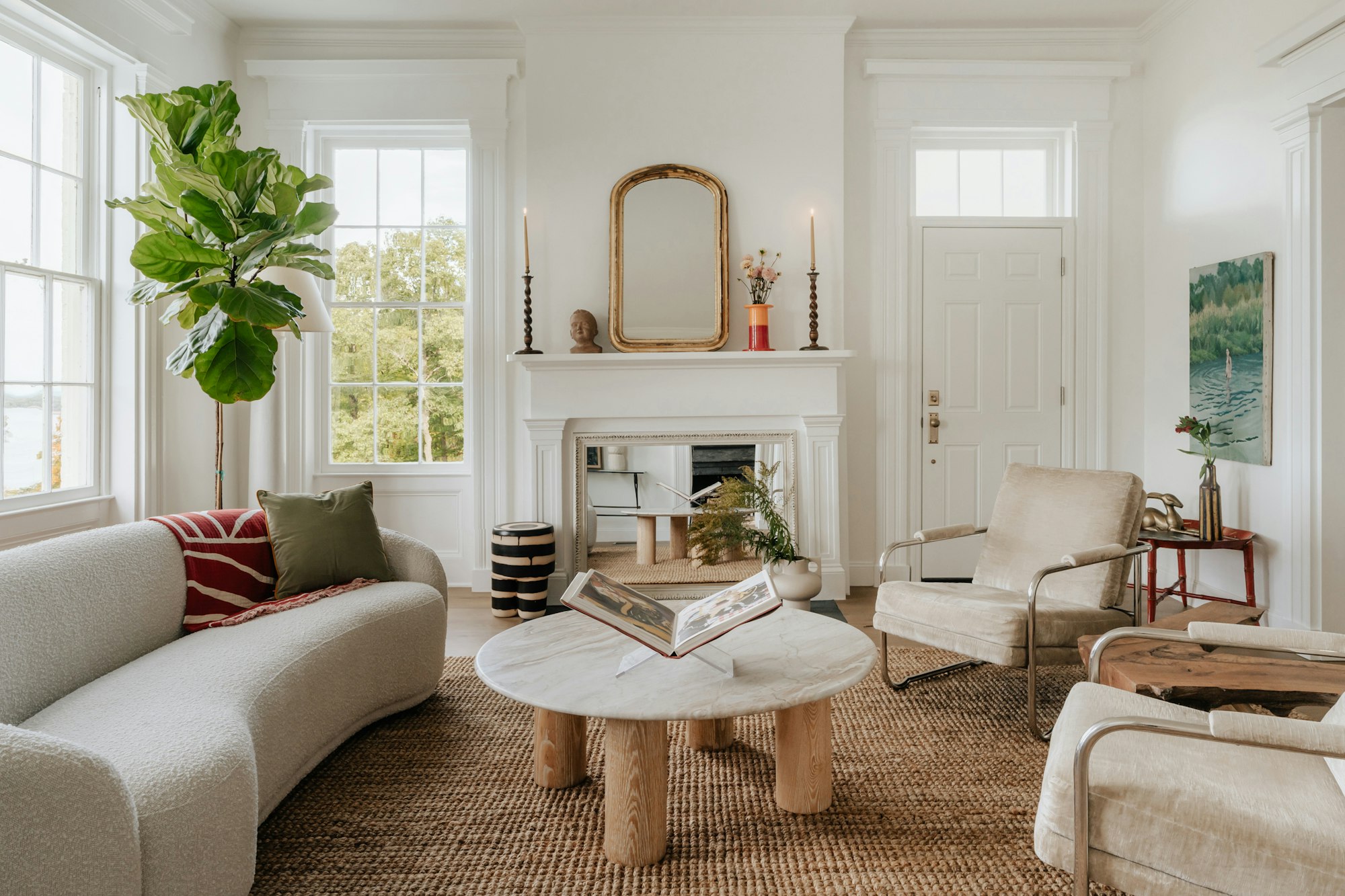 A living room wall styled with woven baskets above a linen sofa