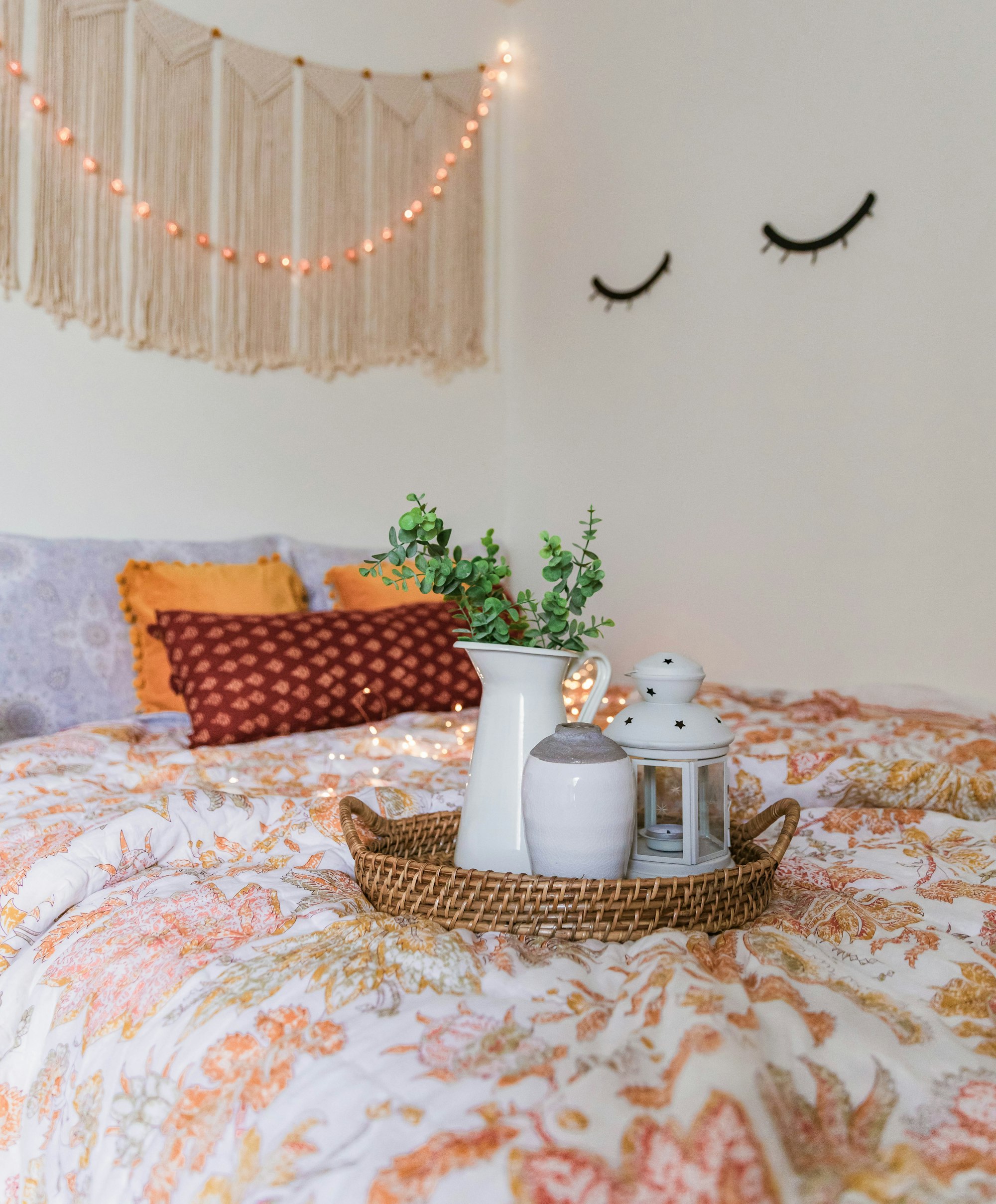 A woven tray with ceramics resting on softly patterned bedding